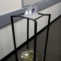 Ice with image inside on a black table melting